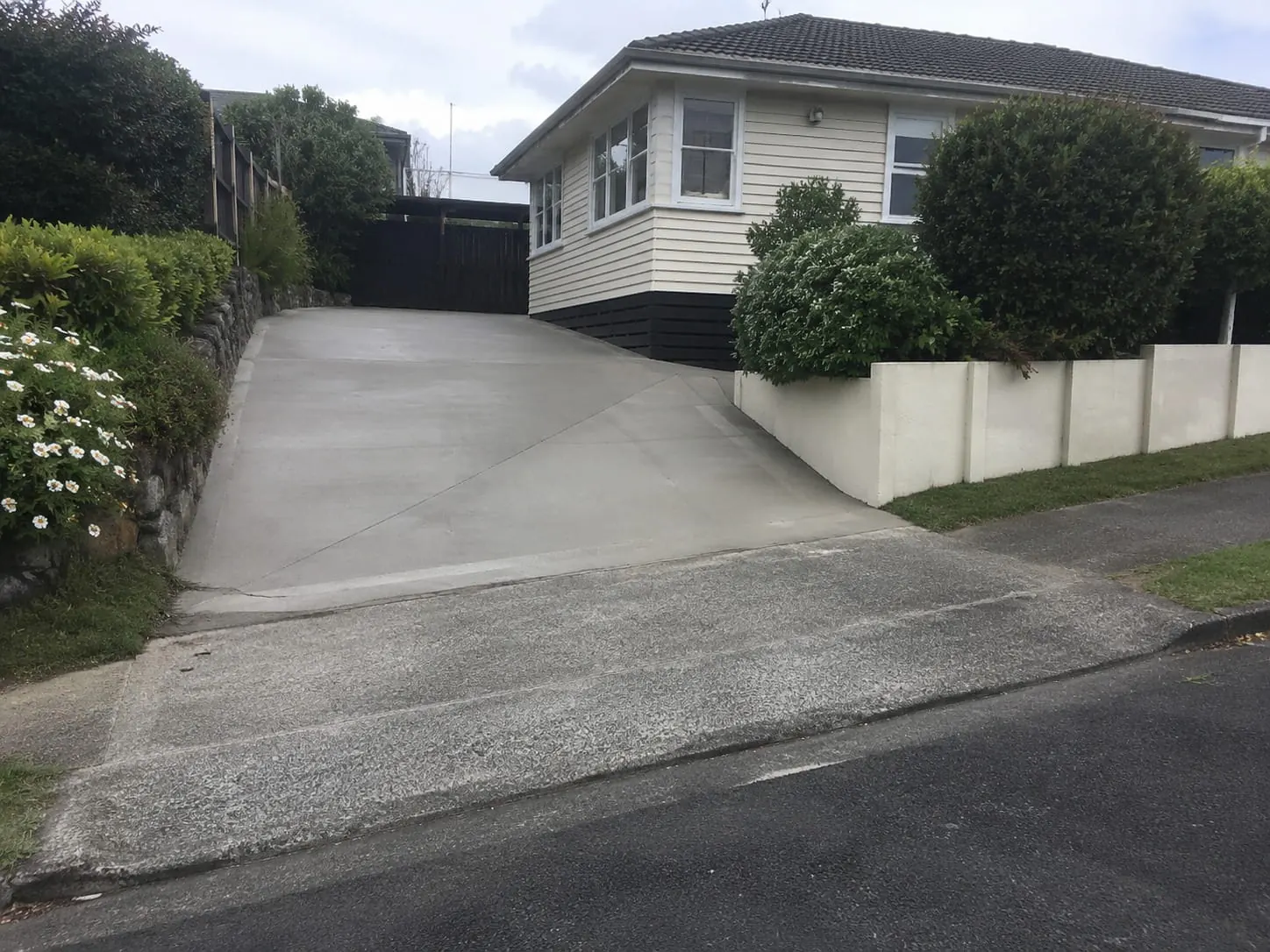 Finished concrete driveway leading to an Auckland garage