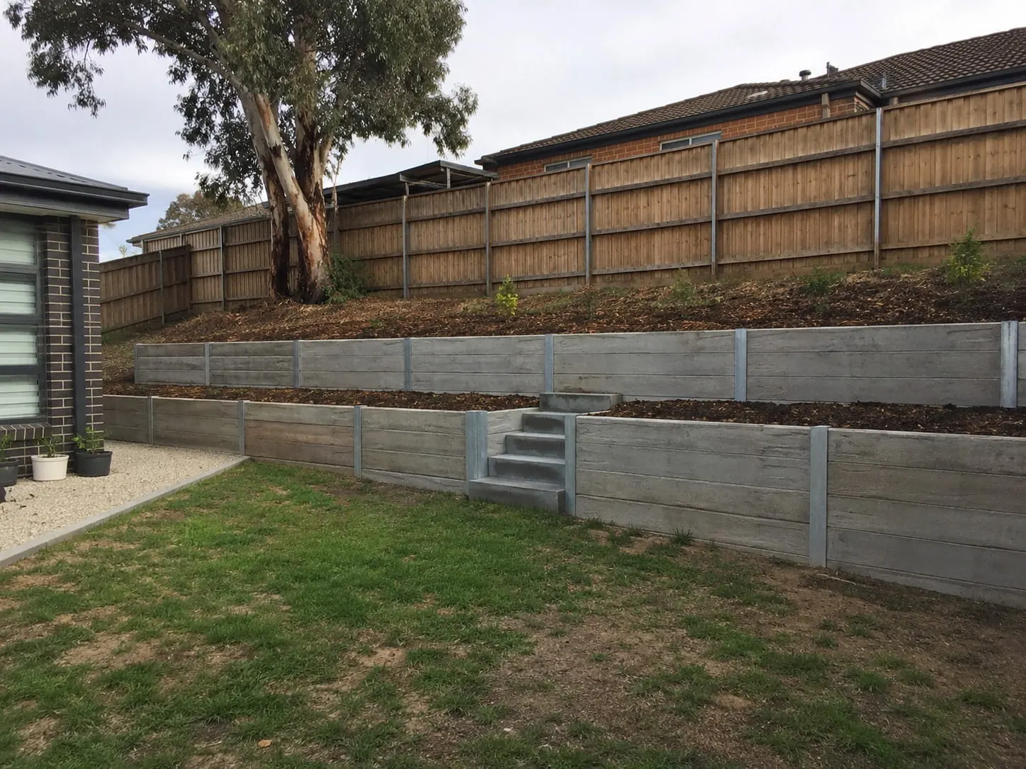 Auckland concrete sleeper wall between steel posts