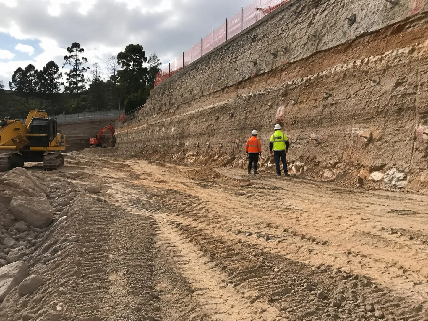 Site supervisors inspecting a shored cut face on an Auckland commercial excavation
