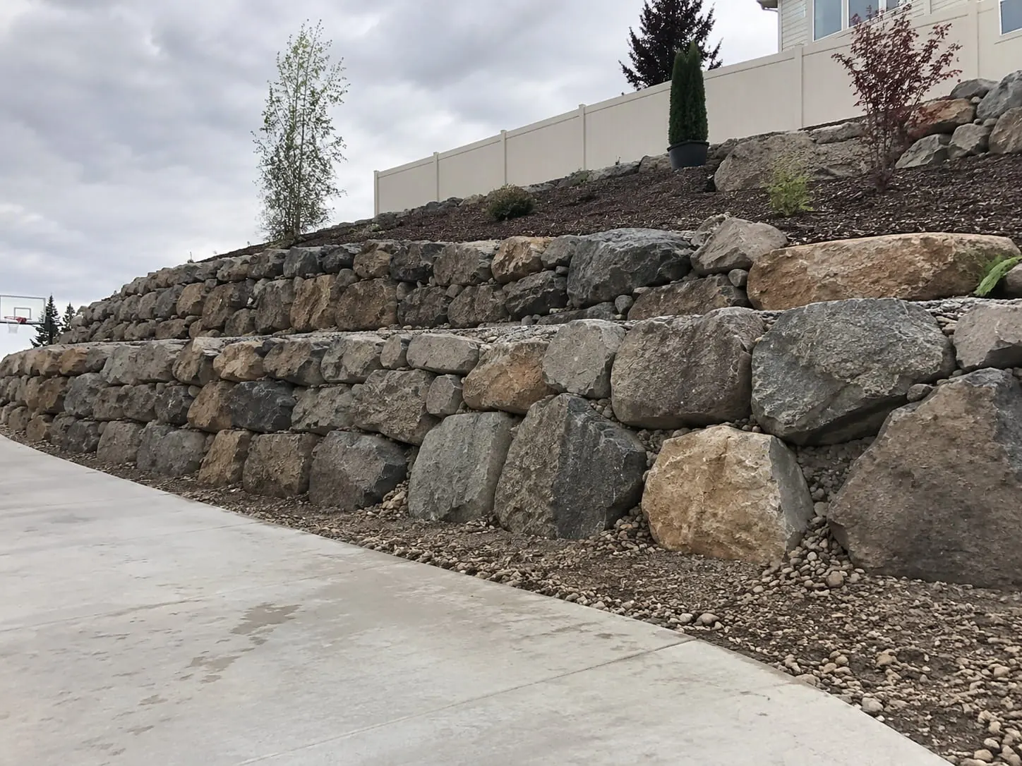 Boulder retaining wall stabilising a steep slope at Huia in the Waitakere Ranges