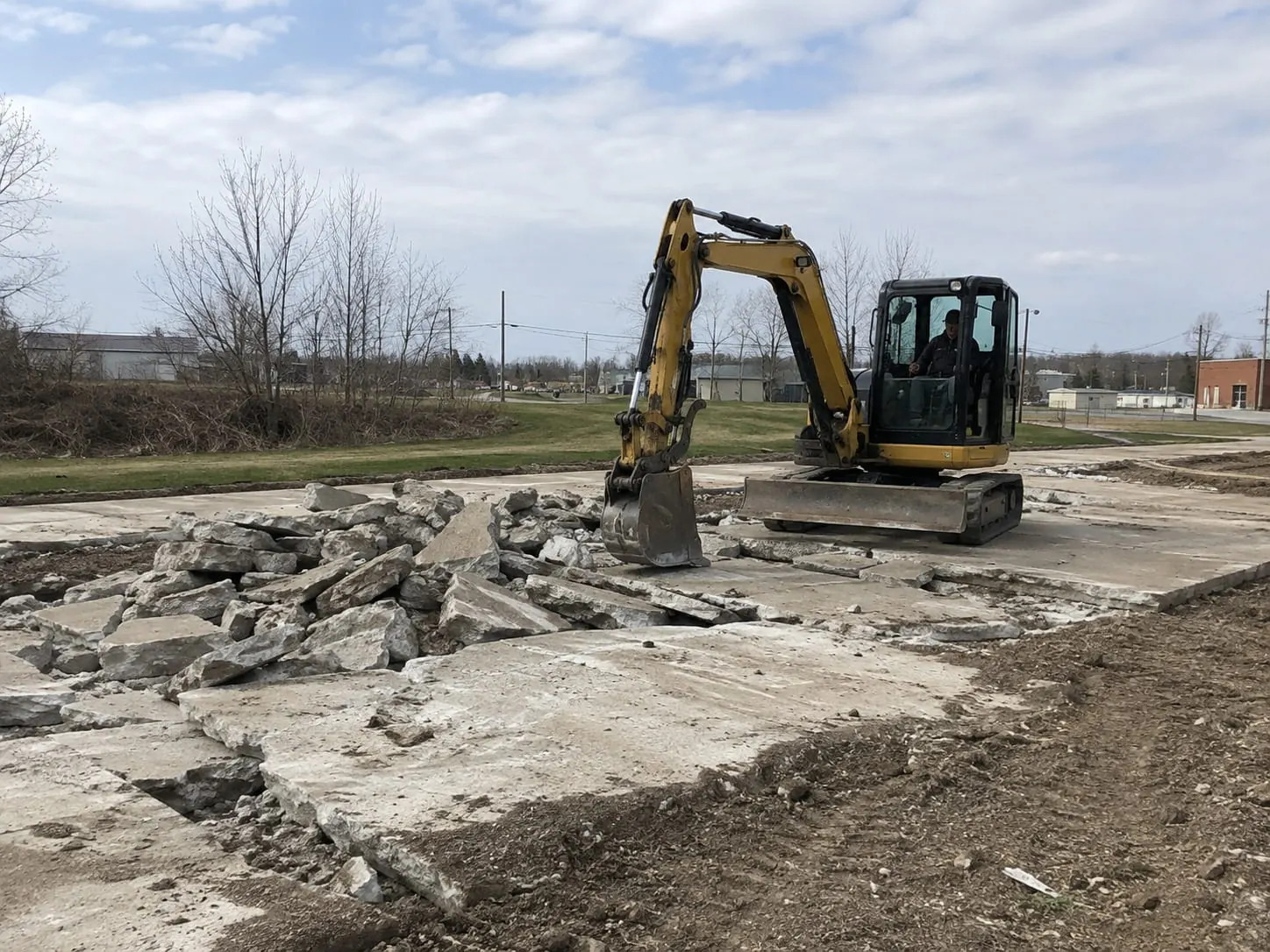 Large concrete retaining wall being demolished on an Auckland site