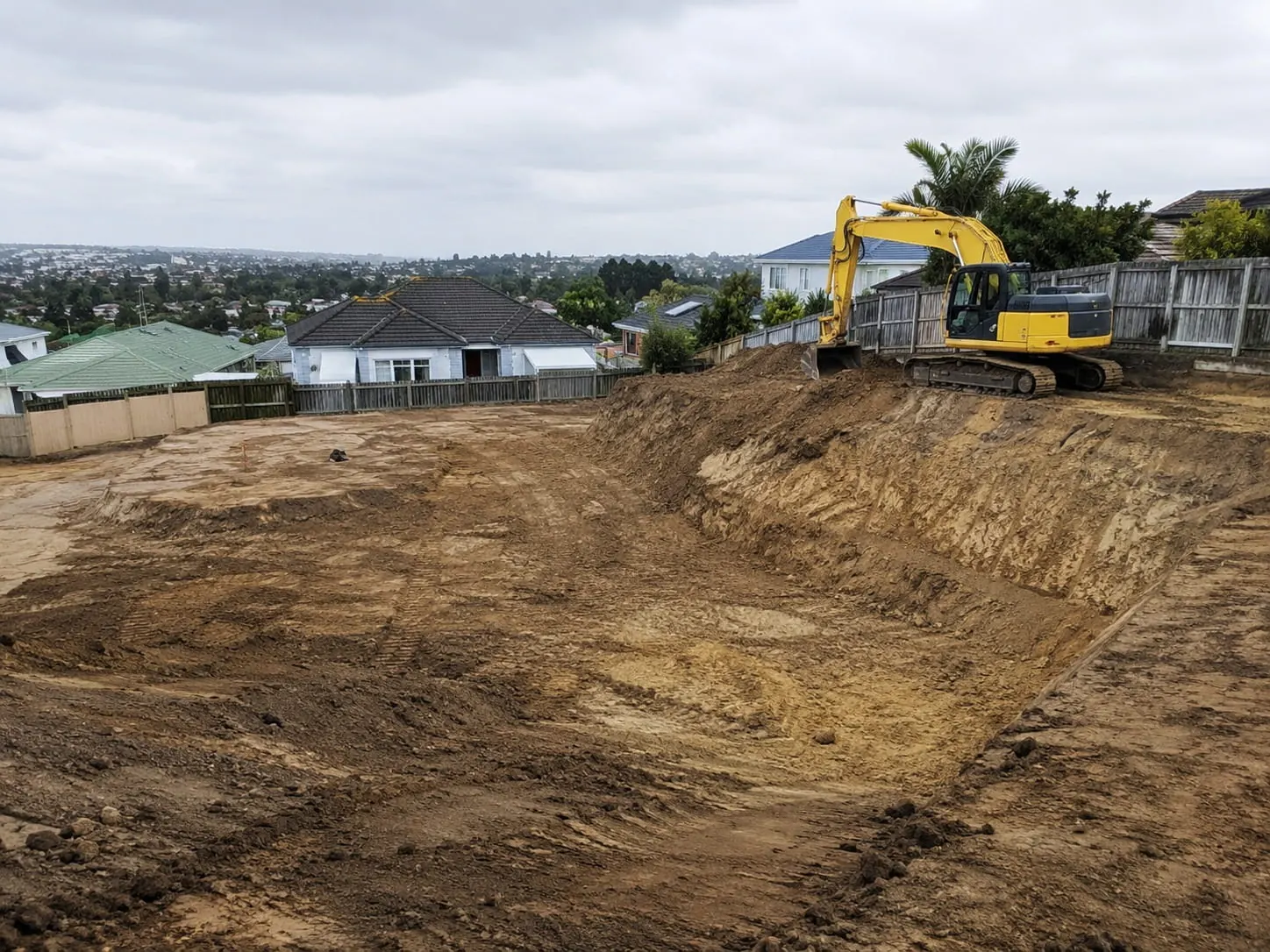 Digger and operator working on an Auckland earthworks job